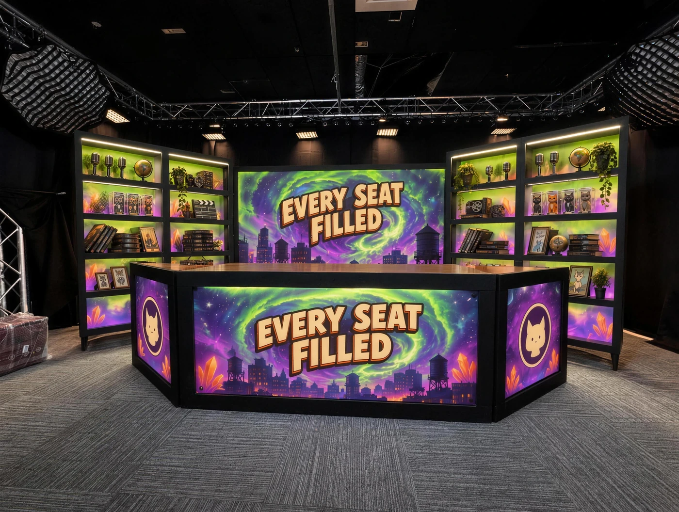 The Every Seat Filled set: a backlit desk printed with the show title and cat coins, between glowing green and violet shelves of Jerry figures, under a portal skyline backdrop